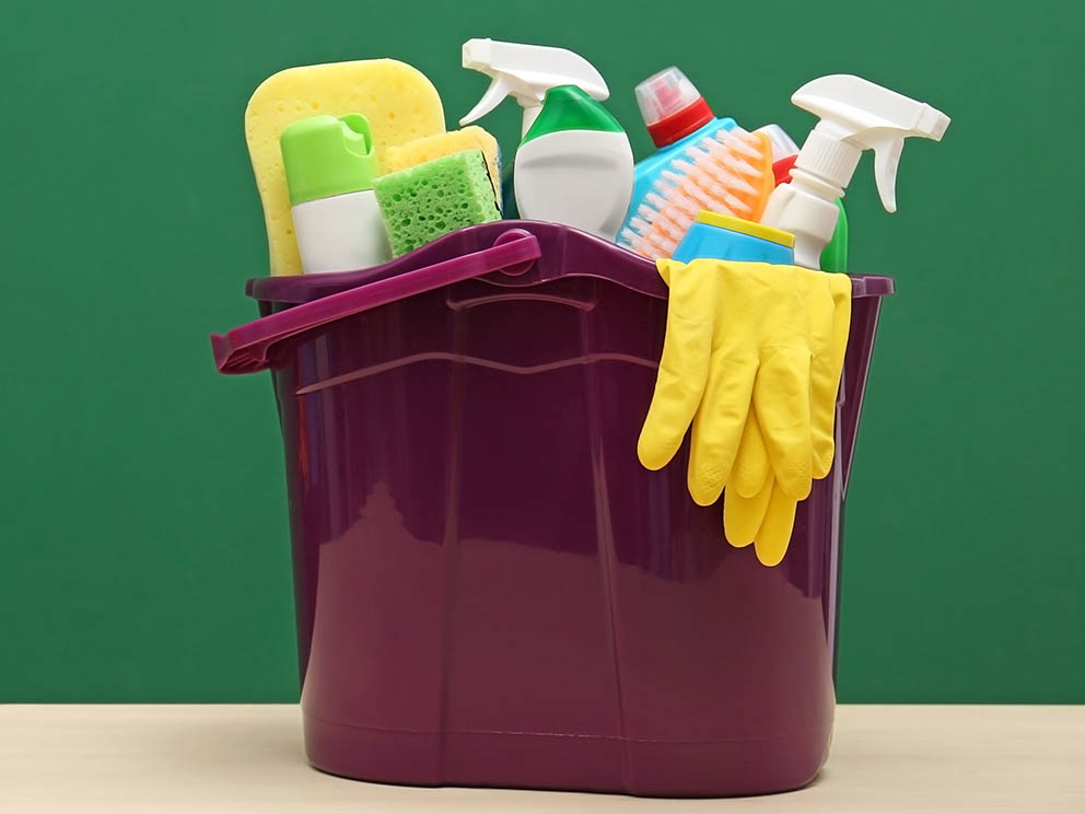 Photo of office janitorial supplies within a bucket. 